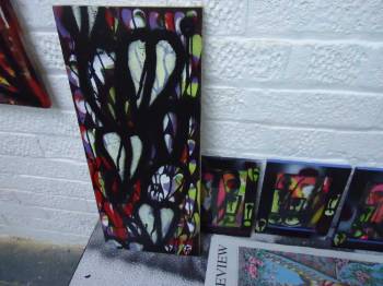 A piece of found wood painted on in the gallery