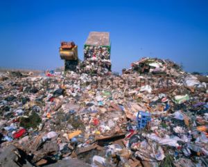 Landfill site with waste truck dumping refuse